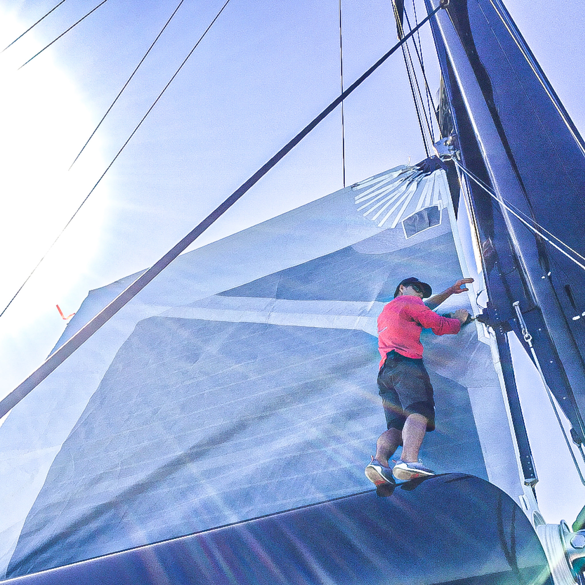 captain on boom of sailboat le Cap Yachts